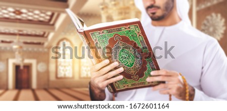 Arabian muslim man reading Quran inside Mosque. Royalty-Free Stock Photo #1672601164