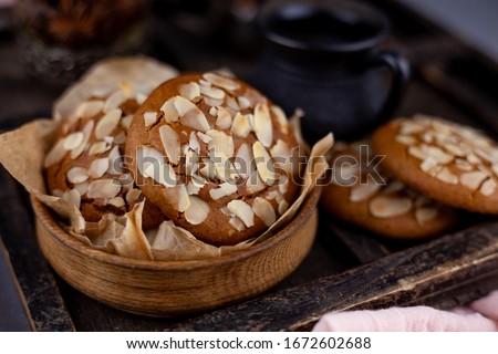 Sweet almond cookies  on wooden table. French homemade cookie. Useful Lenten cookies from almond flour with honey on rustic wooden background. Selective soft focus. Royalty-Free Stock Photo #1672602688