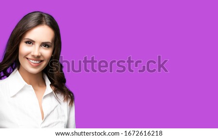 Happy smiling attractive confident businesswoman, with copy space area for some slogan or text. Success in business concept picture. Violet purple color background.