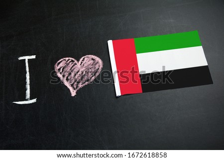 The inscription on the chalkboard I love United Arab Emirates. Flag of UAE on a chalkboard.