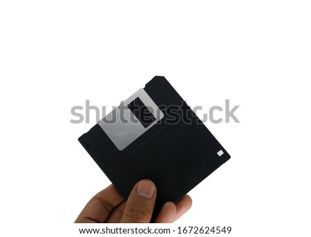 Black floppy disk in men hands old technology for copy data on white background with clippingpath