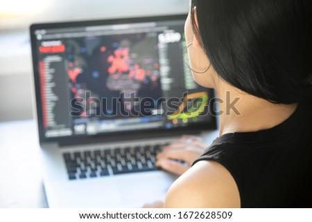Young woman checks coronavirus sars-cov-2 covid-19 global cases situation online. Coronavirus outbreak in United States of America and the rest of the World. Royalty-Free Stock Photo #1672628509