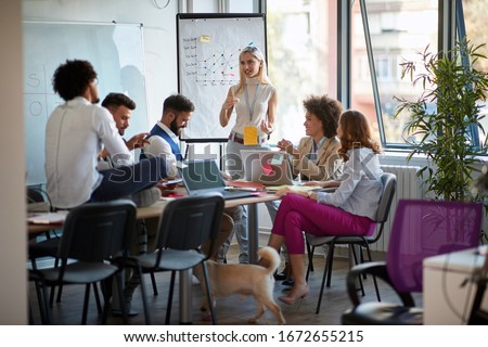 Business young woman  talking on presentation financial statistics at briefing in office. Royalty-Free Stock Photo #1672655215