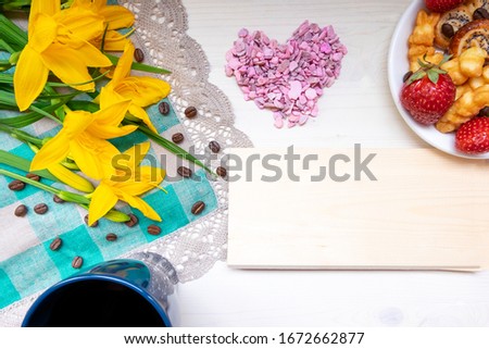 strawberry, cookie hearts with a Cup of grain black coffee, with yellow flowers and a leaf for a note with a Valentine's day mother woman Easter day with love together with a place for text