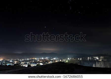 Starry night on the background of the village