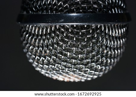 Microphones with wire mesh network photographed in the studio with flash light                         