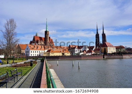 Ostrów Tumski in Wroclaw panorama. The oldest part of the city with colourful, old tenement houses and St. John's the Baptist Archcathedral at the background.