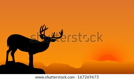 deer silhouette with big horns on a sunset