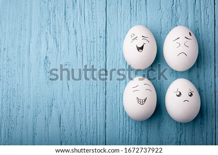 Smile eggs on a bright turquoise blue background. Top view, place for text. Easter concept