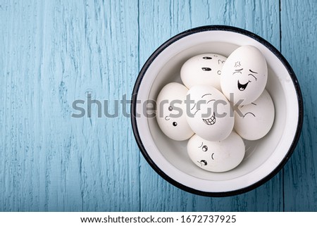 Smile eggs on a bright turquoise blue background. Top view, place for text. Easter concept