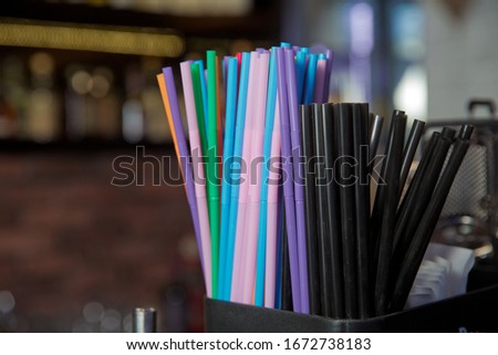 Macro photo drink straw. Stock photo black , blue, pink, plastic drink straws .Mixed vivid color of straw stick black background .