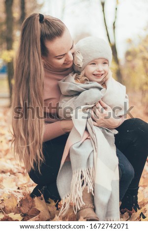 
mother with daughter,mom and daughter on a picnic,
family picnic,mom and daughter are playing in the park,mom hugs daughter,manifestation of mother’s love