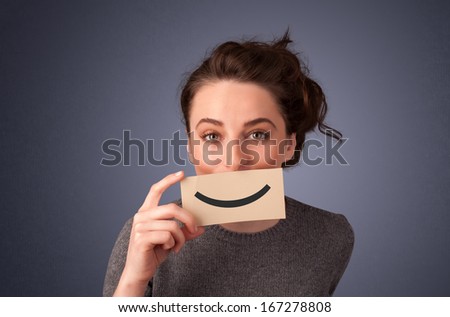 Happy pretty woman holding card with funny smile on gradient background