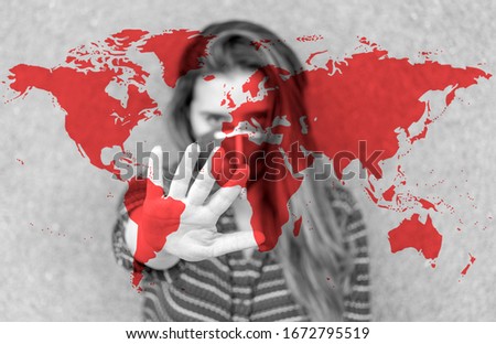 Girl in a mask against the World map background. Stop Coronavirus. 
