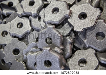 full frame pile of gray steel forgings after shot blasting - close-up natural heavy industrial pattern with selective focus