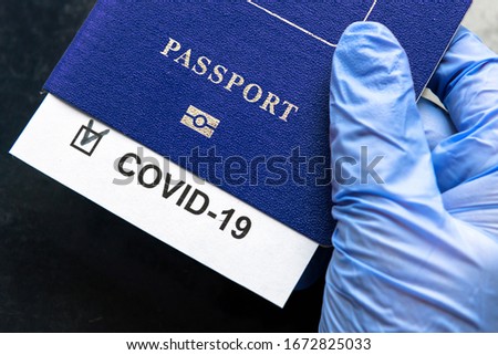 COVID-19, travel, health and lockdown concept, COVID mark in tourist passport. Medical test in airport due to tourism restrictions. Document, passport, corona virus, pass, EU and pandemic theme. Royalty-Free Stock Photo #1672825033