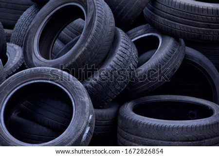 worn out tires in a disorderly heap Royalty-Free Stock Photo #1672826854