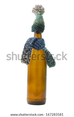 Picture of Beer Bottle with Scarf and Hat. Can be used as concept for presents and cold.