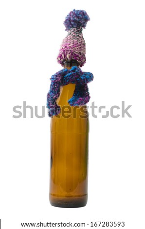 Picture of Beer Bottle with Scarf and Hat. Can be used as concept for presents and cold.