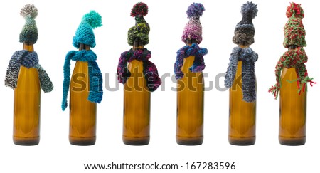 Picture of Beer Bottles in a row with Scarf and Hat. Can be used as concept for presents and cold.
