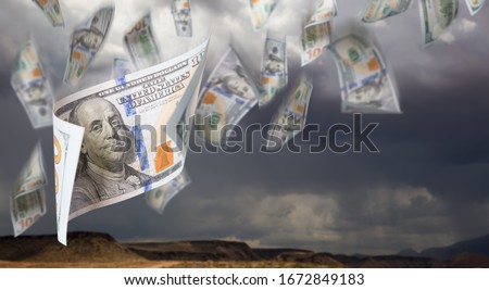 Several 100 Dollar Bills Falling From Stormy Cloudy Sky.