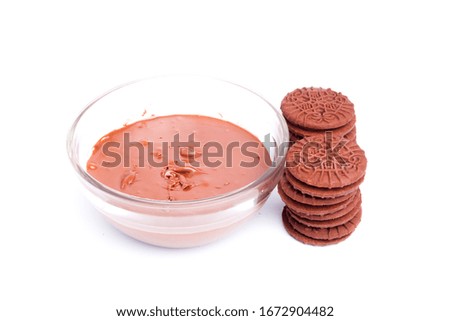 A picture of homemade chocolate biscuit with chocolate spread on white background.