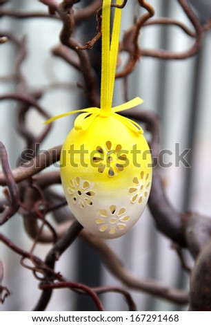 Mix of beautiful handmade easter colored eggs hanging on the tree 