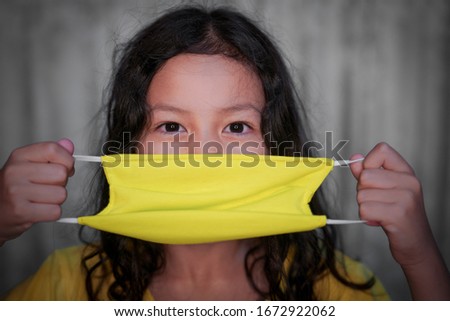 Asian little cute girl wearing a mask for protect coronavirus.