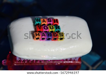 Wash your hands, words spelled out in abc color blocks on bar of soap. Hand washing prevents infection with virus and bacteria.