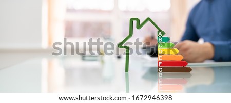 Cropped Image Of Businessman Calculating Energy Efficiency Rate In Office Royalty-Free Stock Photo #1672946398