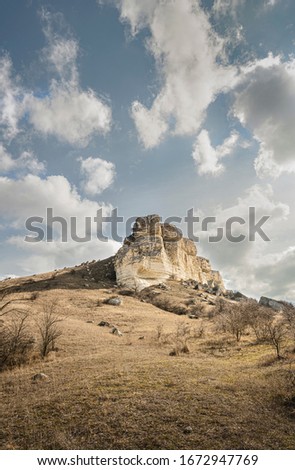 White rock in spring. Mountains. Clear blue sky. Scenic view. Vertical layout for mobile apps