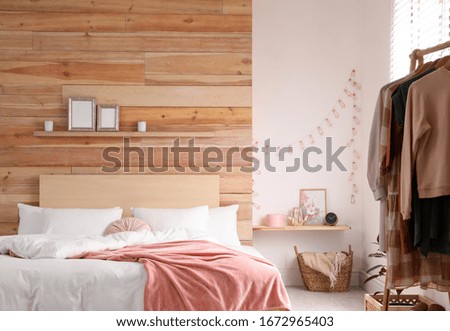 Large comfortable bed in stylish room interior
