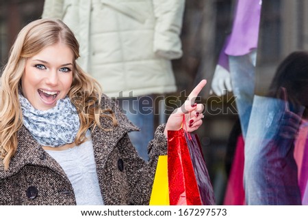 Beautiful young woman looks excited about the merchandise 