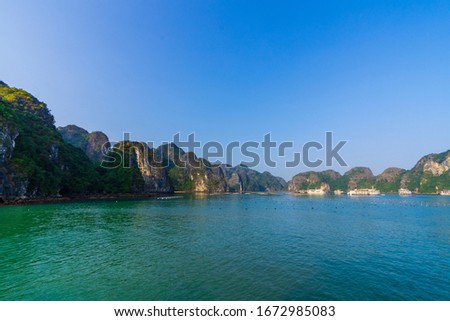 Green Limestone Islands in Blue Waters of Halong Bay