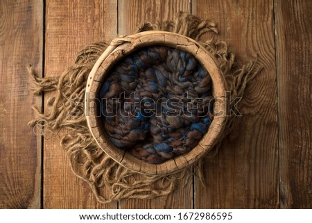 Newborn photography digital background prop. wood basket with blue fur and on a wooden background.