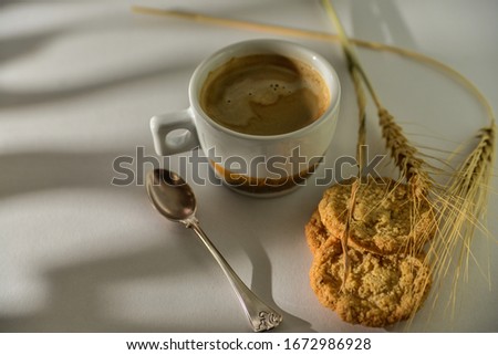 cup of coffee and biscuits on the table