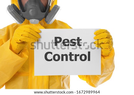 Man wearing protective suit holding sign PEST CONTROL on white background, closeup