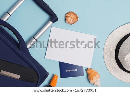 Suitcase, passport, sunglasses and empty paper. Travel mock-up. Summer vacation flat lay.