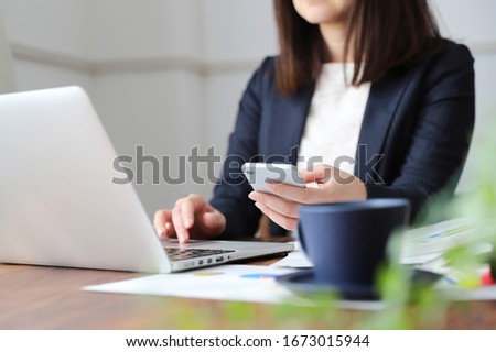 A woman in a suit doing telework at home Royalty-Free Stock Photo #1673015944