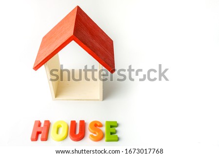 wooden mini house with word house on the white backgroound as business, family and property concept