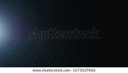 natural dust particles flow in air on black background Royalty-Free Stock Photo #1673029066