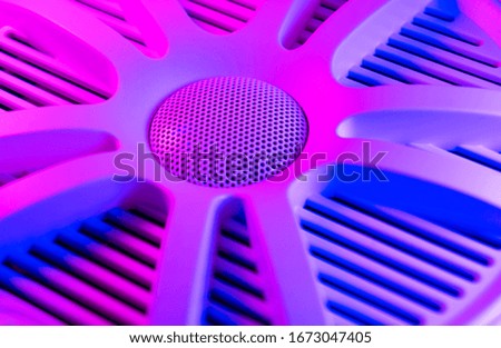 Colorful lights of car stereo and car speakers background.  Car music audio speaker in blue and pink tones. Car audio system close up