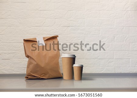 Paper bag on table against white background. Mockup for design