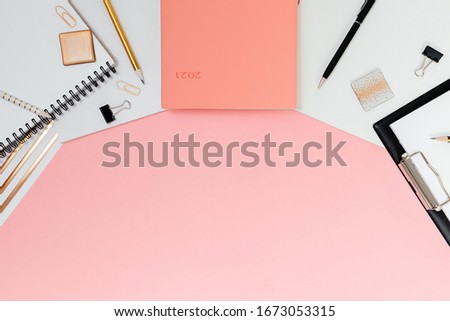 Mockup planner flat lay, top horizontal view pink background. Notepad and notebooks with stationary. Golden, white, pink and black c