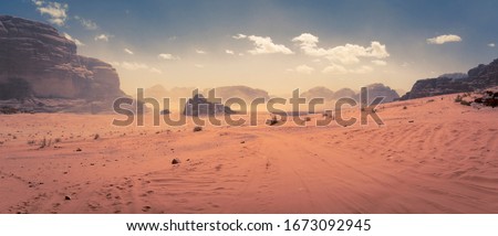 Panorama of the Wadi Rum desert in Jordan during a slight sand storm Royalty-Free Stock Photo #1673092945