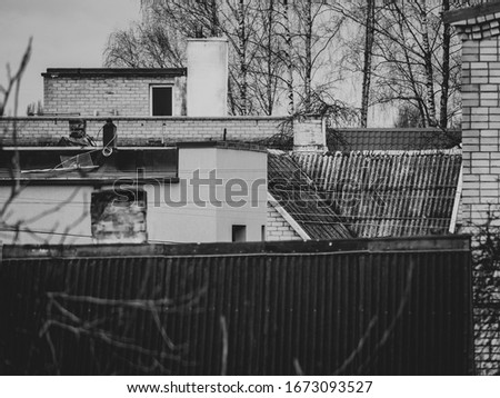 Abandoned city: slate roofs of the old houses, chimneys in black and white