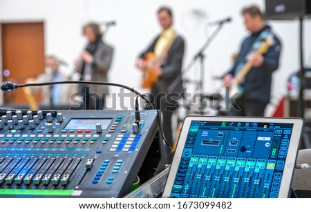 audio mixing console for controlling the sound of a music band at a concert