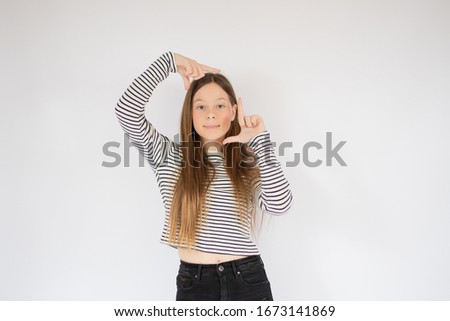 Young girl making portrait gesture