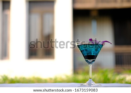 Blue martini cocktail and summer drink background