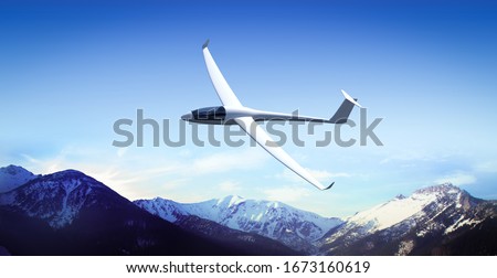 The glider is flying in the mountains Royalty-Free Stock Photo #1673160619